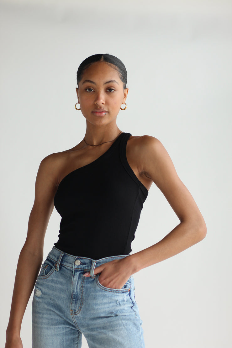 A girl wearing a black one shoulder top