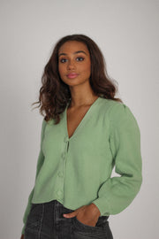 Girl wearing sweater with buttons#color_mint-green
