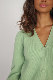 Girl wearing sweater with buttons#color_mint-green