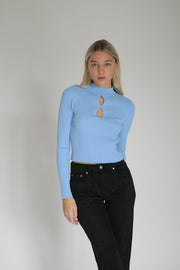 A Girl Wearing a long sleeve blue top#color_blue-noise