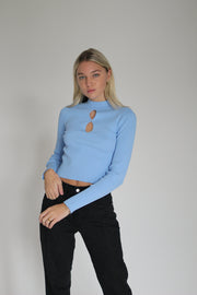 A Girl Wearing a long sleeve blue top#color_blue-noise